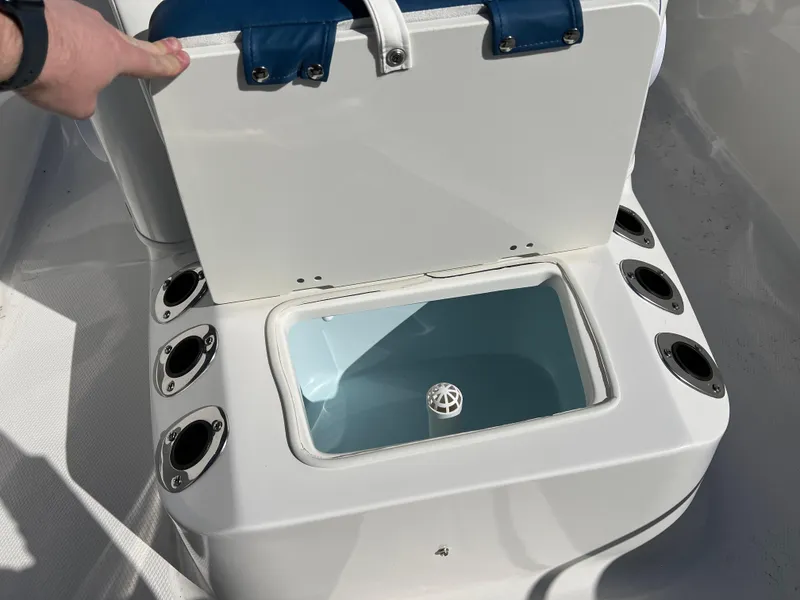 Slide: The Image of 2025 Robalo R160 Center Console livewell with rod holders and open lid. - 17