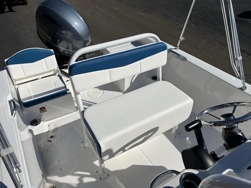 Slide: The Image of 2025 Robalo R160 Center Console boat interior with seating and steering wheel. - 18