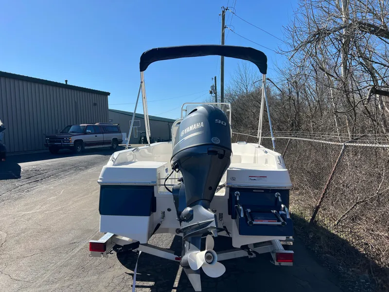 Slide: The Image of 2025 Robalo R160 Center Console boat with Yamaha engine, parked outdoors. - 3