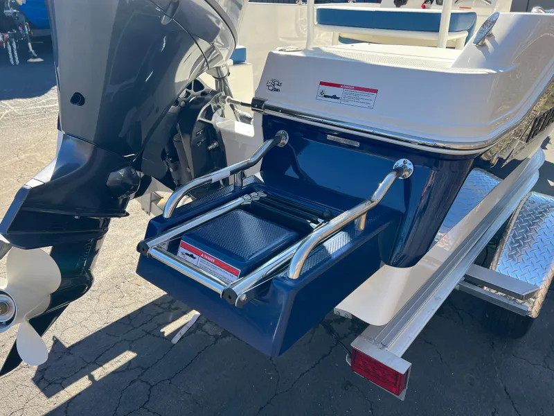 Slide: The Image of 2025 Robalo R160 Center Console boat with motor and swim platform. - 4