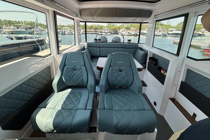 Slide: The Image of Interior of 2022 Axopar 37XC boat with luxurious seating and panoramic windows. - 11