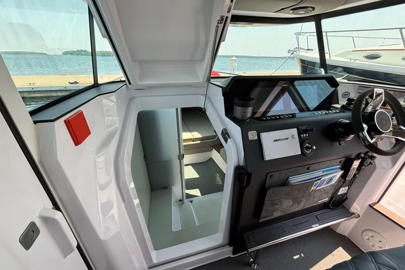 Slide: The Image of Interior view of 2022 Axopar 37XC boat cockpit with steering wheel and navigation equipment. - 12