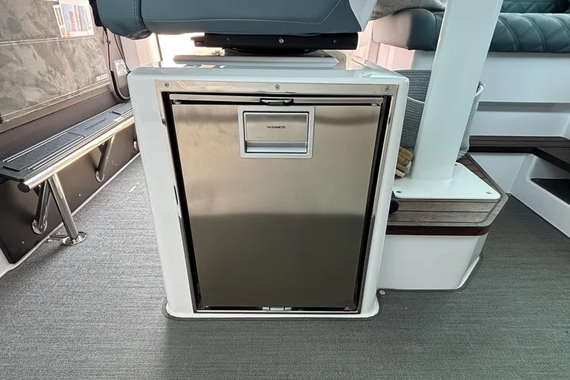 Slide: The Image of Stainless steel refrigerator inside 2022 Axopar 37XC boat interior, featuring modern design elements. - 15