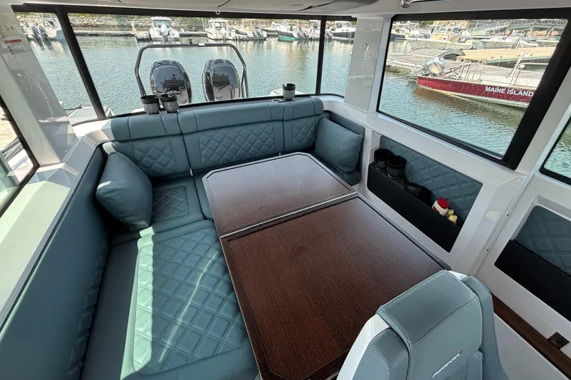 Slide: The Image of Luxurious interior of 2022 Axopar 37XC boat with elegant seating and table. - 16