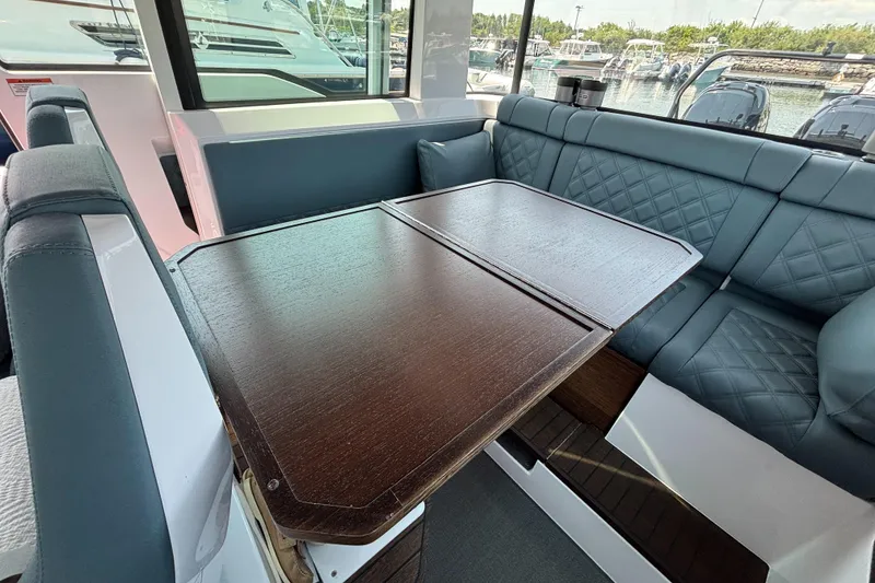 Slide: The Image of Interior of 2022 Axopar 37XC with elegant seating and wooden table. - 17