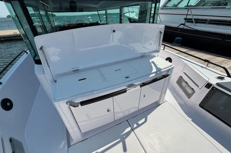 Slide: The Image of 2022 Axopar 37XC boat interior with open storage compartments and sleek design. - 24