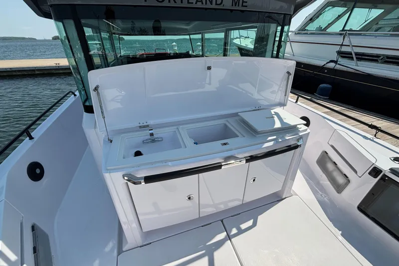 Slide: The Image of 2022 Axopar 37XC boat with outdoor sink and storage area. - 25