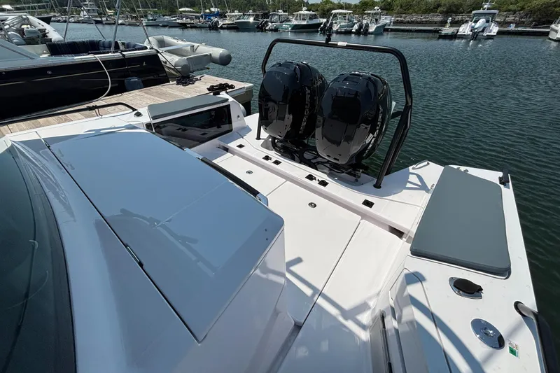 Slide: The Image of 2022 Axopar 37XC boat with dual engines docked at a marina. - 26