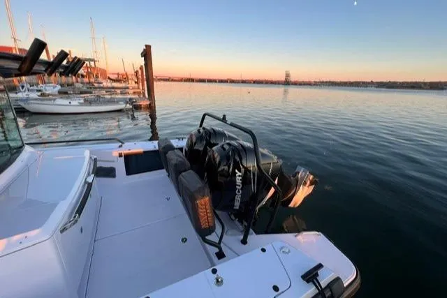 Slide: The Image of 2022 Axopar 37XC boat docked at sunset with calm waters. - 27