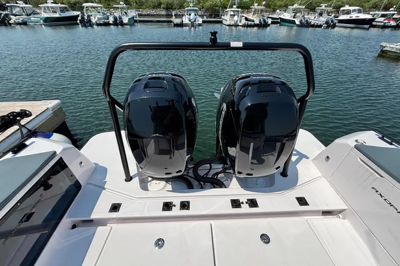Slide: The Image of 2022 Axopar 37XC boat with dual engines docked in a marina. - 28