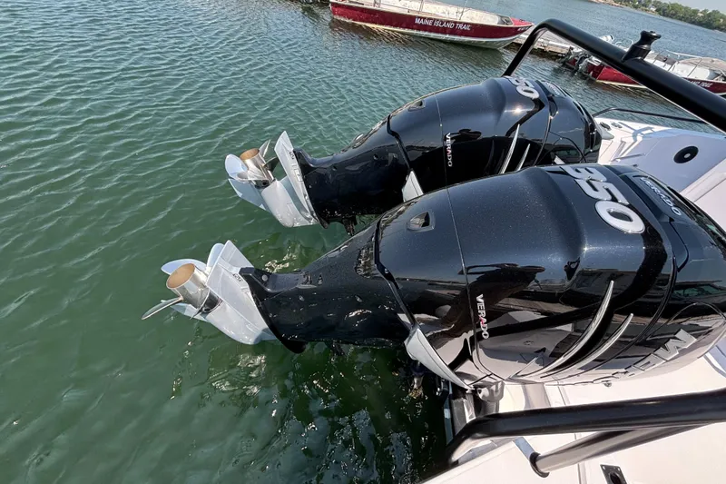 Slide: The Image of Twin outboard engines on a 2022 Axopar 37XC boat in water. - 29