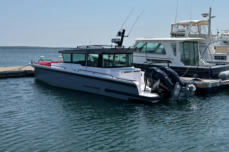 Slide: The Image of 2022 Axopar 37XC boat docked in a marina, featuring sleek design and modern amenities. - 3