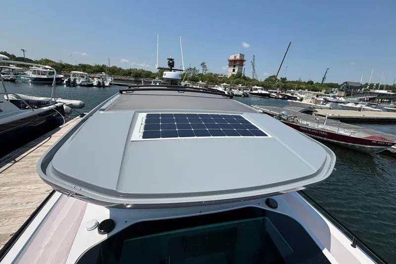 Slide: The Image of 2022 Axopar 37XC boat with solar panel on roof, docked at marina. - 35