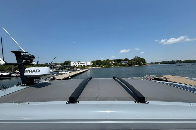Slide: The Image of 2022 Axopar 37XC boat docked at marina under clear blue sky. - 36