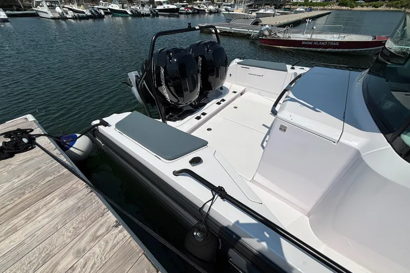 Slide: The Image of 2022 Axopar 37XC boat docked, featuring dual outboard motors and sleek design. - 37