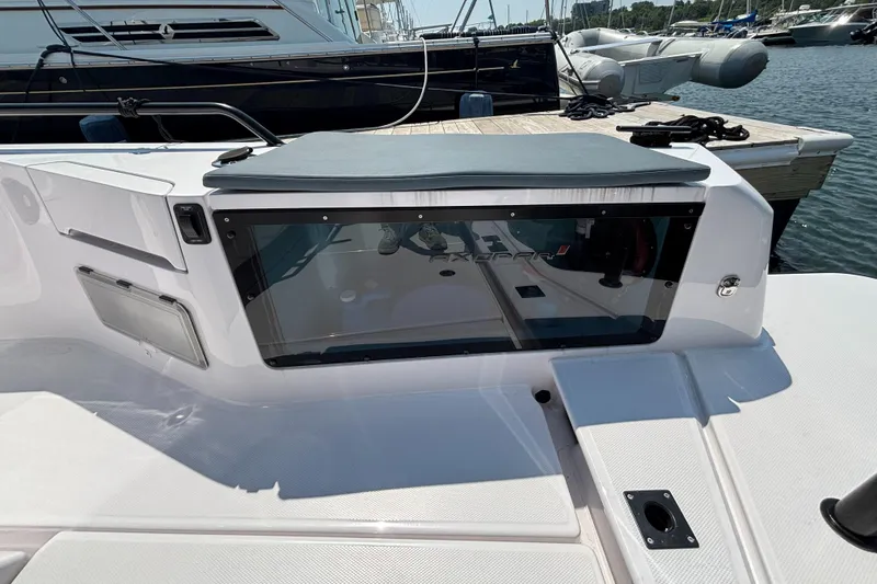 Slide: The Image of 2022 Axopar 37XC boat interior with sleek design and modern features at a marina. - 39