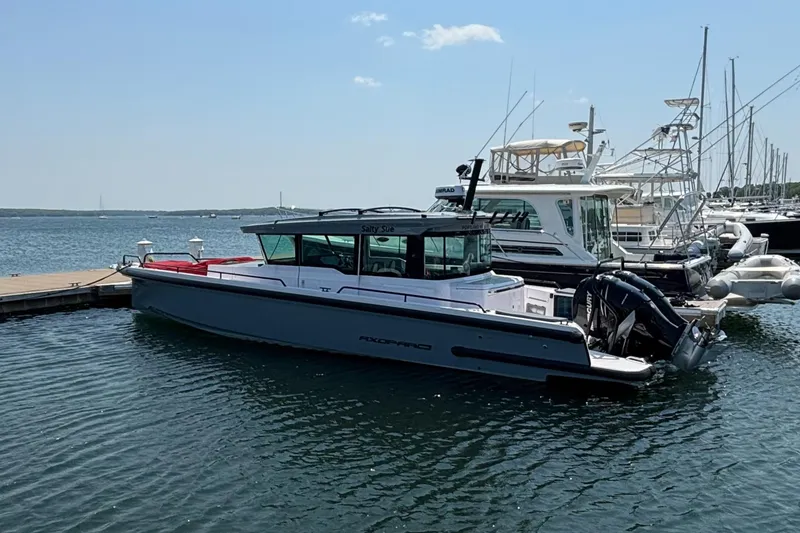 Slide: The Image of 2022 Axopar 37XC boat docked in a marina on a sunny day. - 7