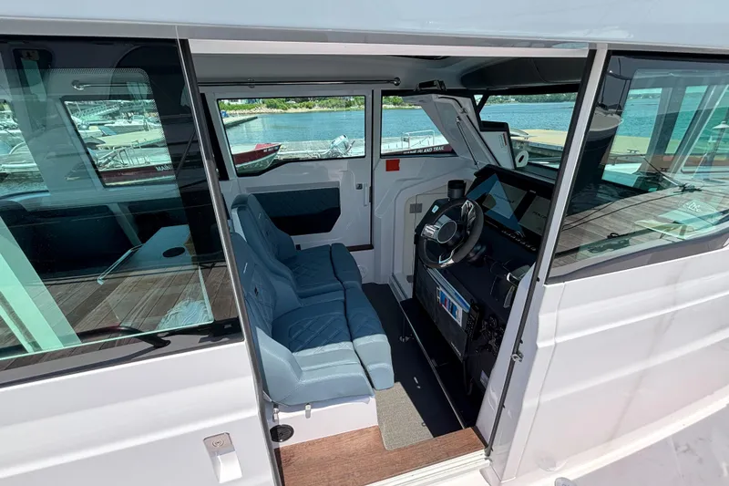 Slide: The Image of Interior view of 2022 Axopar 37XC boat, featuring helm and seating area. - 9