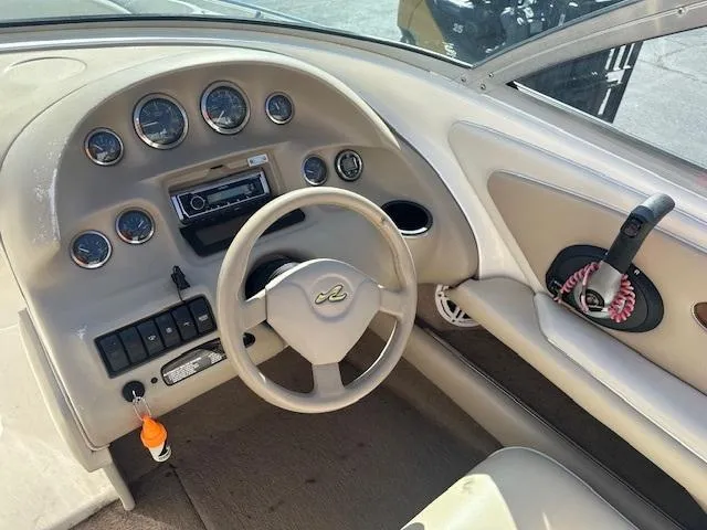 Slide: The Image of 1997 Sea Ray 210 Bowrider dashboard with steering wheel and instrument panel. - 3