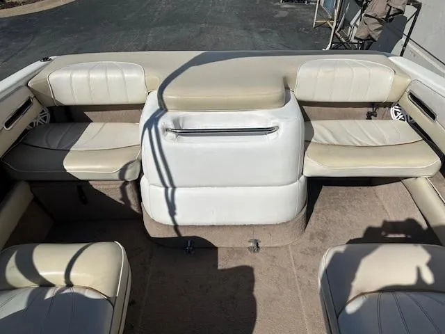 Slide: The Image of 1997 Sea Ray 210 Bowrider interior with beige seating and carpeted floor. - 7