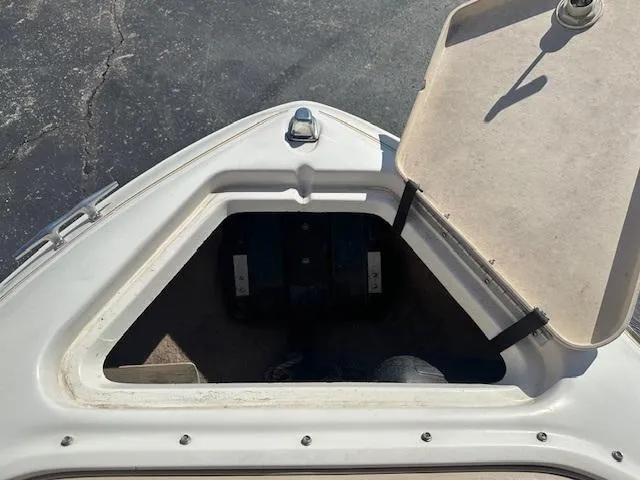 Slide: The Image of 1997 Sea Ray 210 Bowrider open storage compartment on deck. - 8