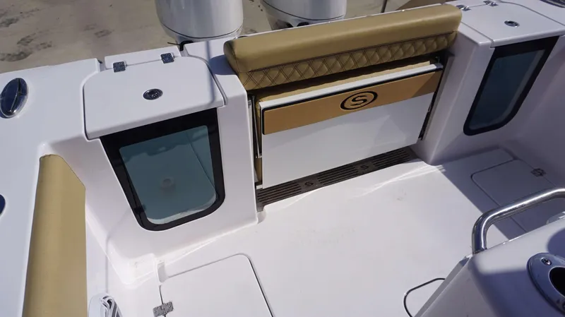 Slide: The Image of 2025 Sportsman 262 Open boat interior with tan seating and storage compartments. - 10