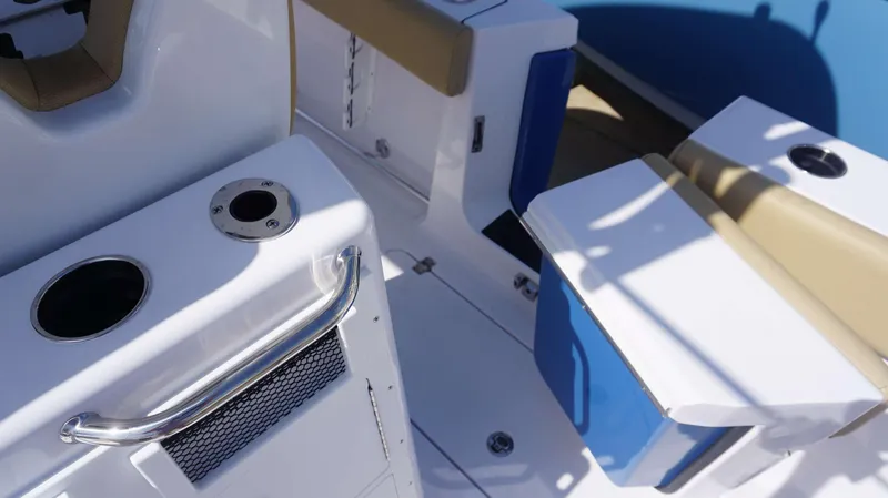 Slide: The Image of Interior view of 2025 Sportsman 262 Open boat, featuring seating and cup holders. - 13