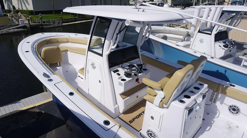 Slide: The Image of 2025 Sportsman 262 Open boat with modern helm and seating, docked at marina. - 3