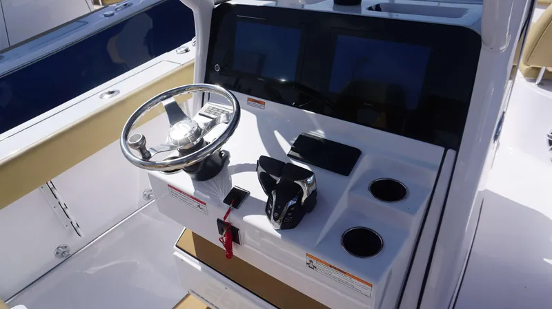 Slide: The Image of 2025 Sportsman 262 Open boat console with steering wheel and controls. - 7