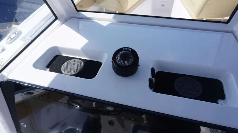 Slide: The Image of 2025 Sportsman 262 Open boat dashboard with compass and speakers. - 8