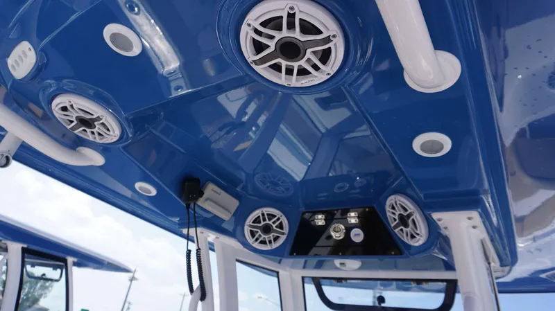 Slide: The Image of 2025 Sportsman 262 Open boat interior with blue ceiling and speakers. - 9