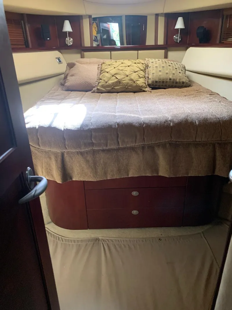 Slide: The Image of Interior cabin of 2006 Sea Ray 52 Sedan Bridge with cozy bed and pillows. - 10