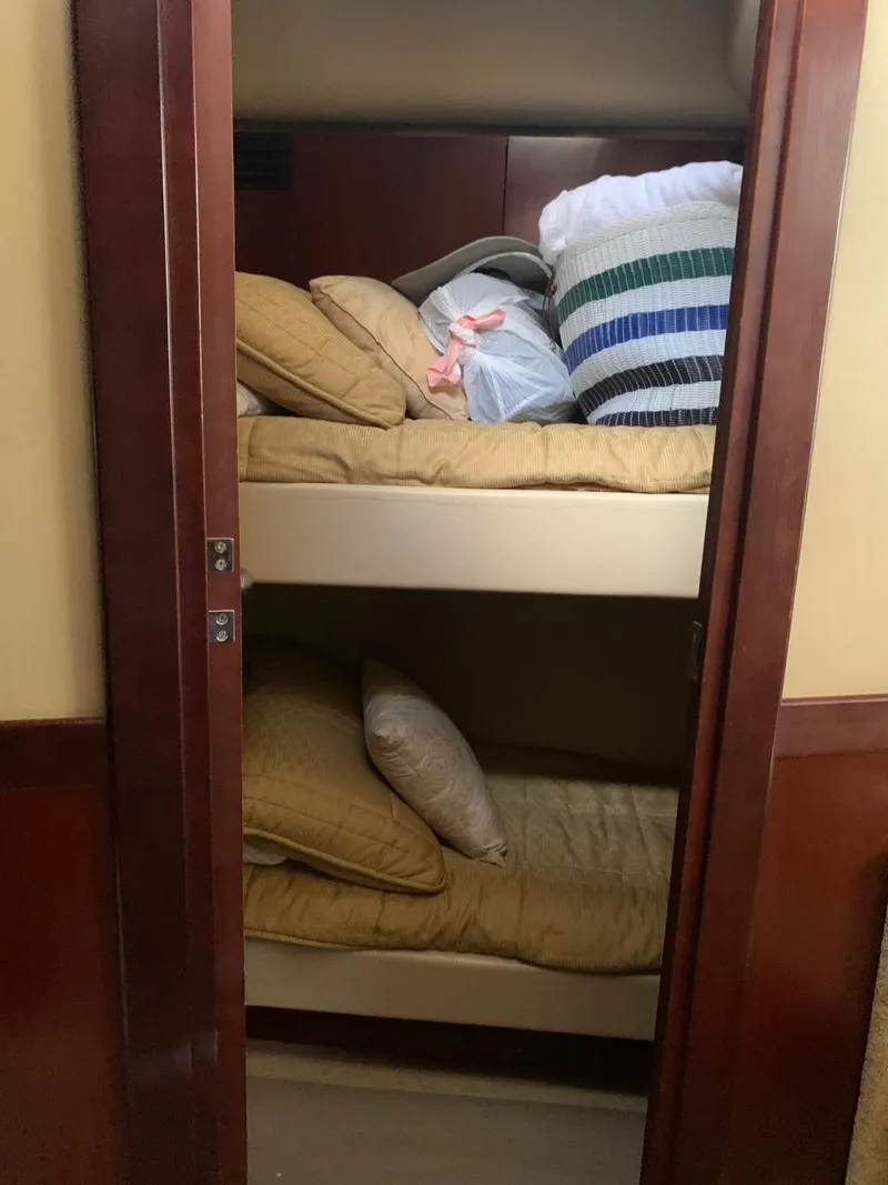 Slide: The Image of Bunk beds in 2006 Sea Ray 52 Sedan Bridge yacht cabin with pillows and bedding. - 13