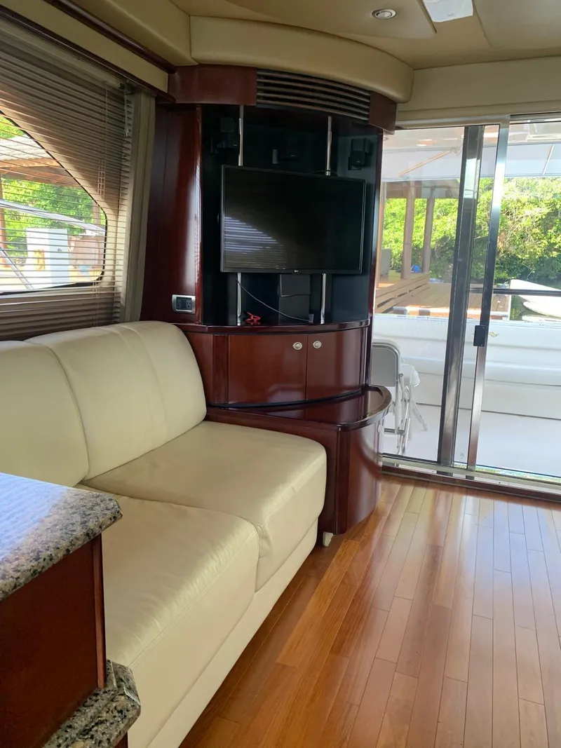 Slide: The Image of Interior of 2006 Sea Ray 52 Sedan Bridge yacht with sofa and TV. - 15