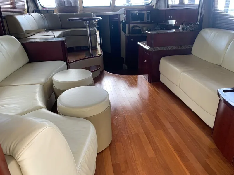 Slide: The Image of Luxurious interior of 2006 Sea Ray 52 Sedan Bridge yacht with leather seating and wood flooring. - 18