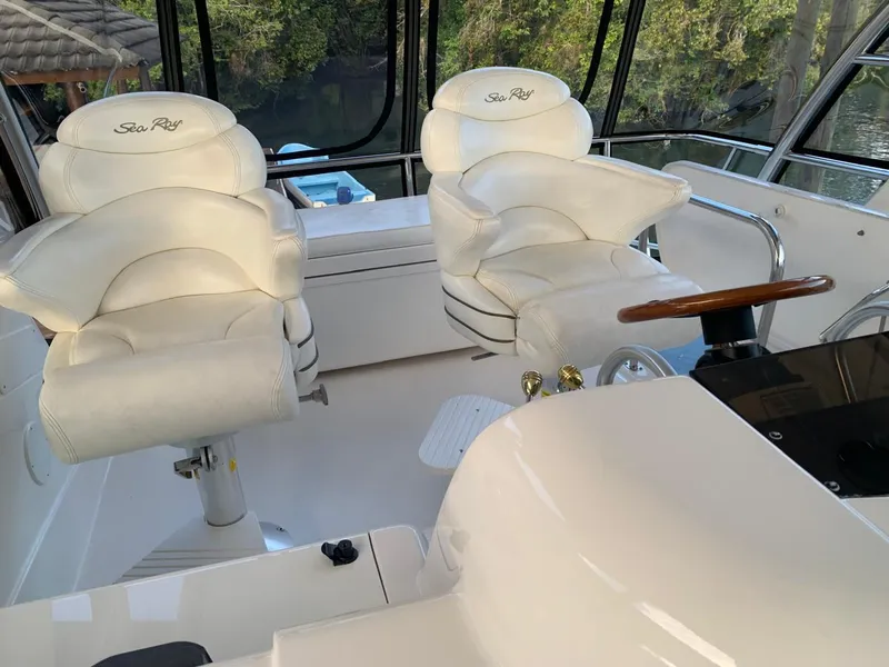 Slide: The Image of Interior of 2006 Sea Ray 52 Sedan Bridge with white captain chairs and steering wheel. - 6