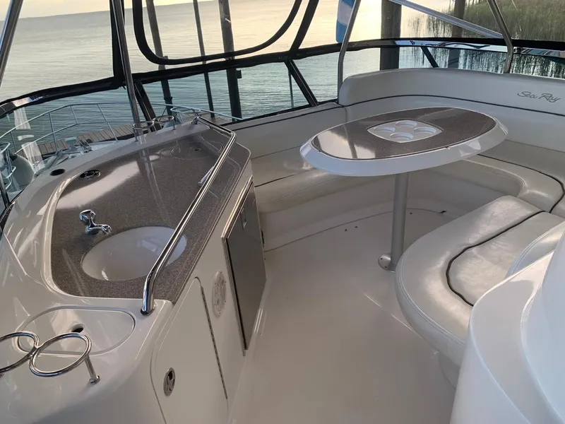 Slide: The Image of 2006 Sea Ray 52 Sedan Bridge interior with kitchenette and seating area. - 7