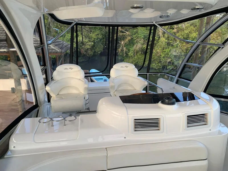 Slide: The Image of 2006 Sea Ray 52 Sedan Bridge interior with white seating and control panel. - 8