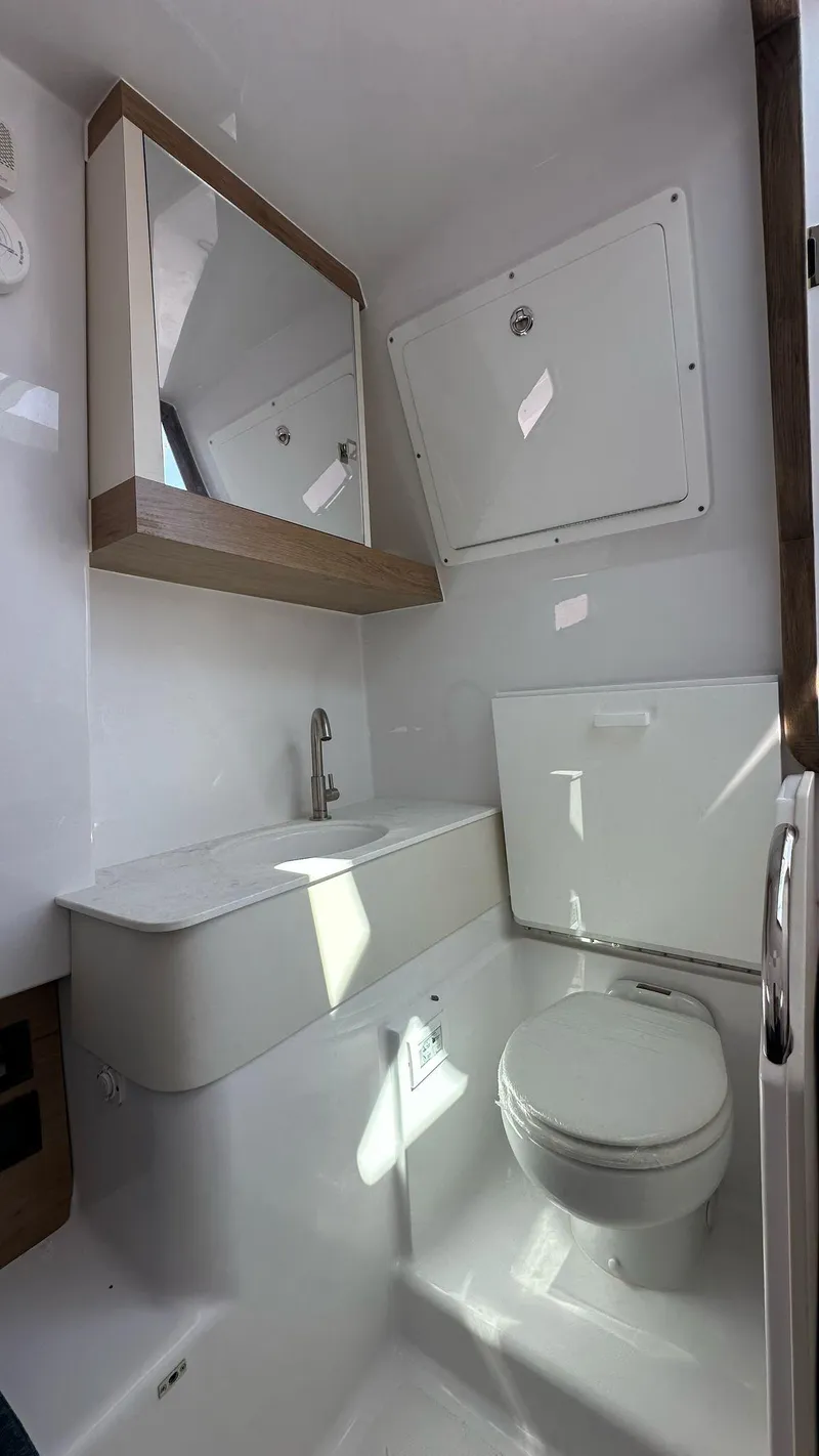 Slide: The Image of Modern bathroom in 2025 Bertram 34 CC boat with sleek fixtures and mirror. - 11