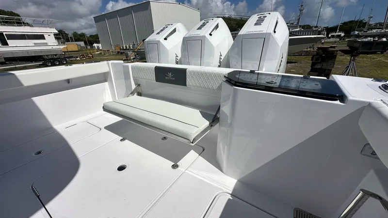 Slide: The Image of 2025 Bertram 34 CC boat with triple outboard engines and sleek white seating. - 12