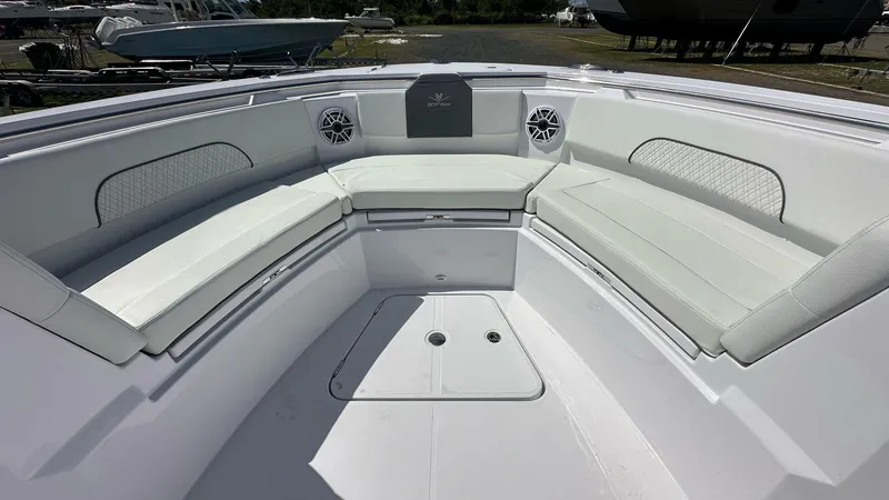 Slide: The Image of 2025 Bertram 34 CC boat interior with white cushioned seating and modern design. - 3