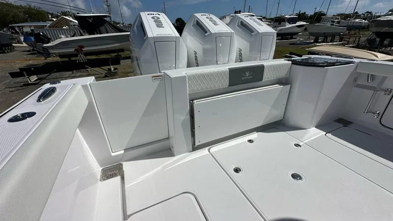 Slide: The Image of 2025 Bertram 34 CC boat deck with modern design and powerful outboard engines. - 4