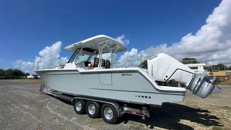 Slide: The Image of 2025 Bertram 34 CC boat on trailer under clear blue sky. - 5