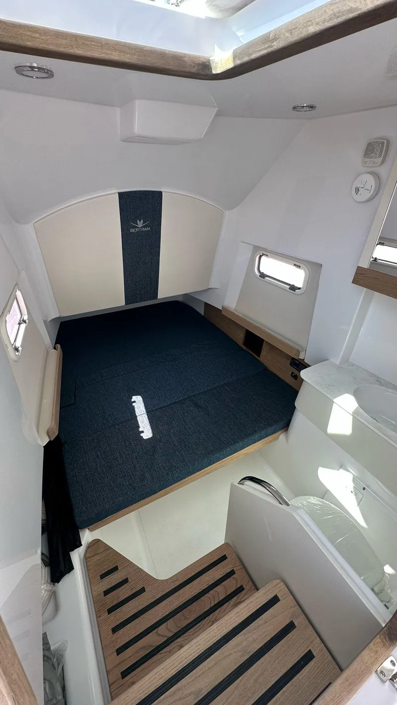 Slide: The Image of 2025 Bertram 34 CC cabin interior with modern design and comfortable sleeping area. - 7