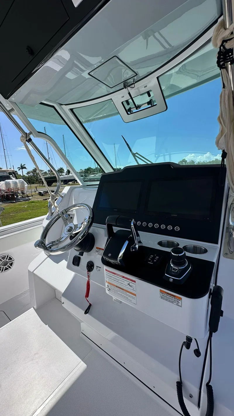 Slide: The Image of 2025 Bertram 34 CC boat cockpit with modern controls and steering wheel. - 8