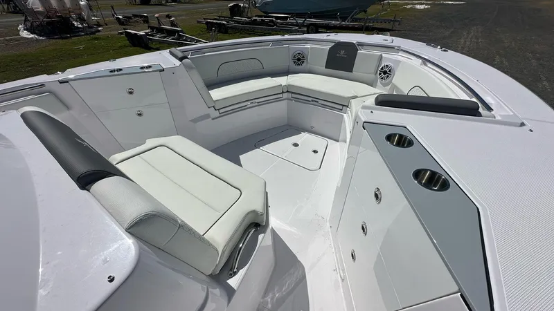 Slide: The Image of 2025 Bertram 34 CC boat interior with white seating and cup holders. - 9