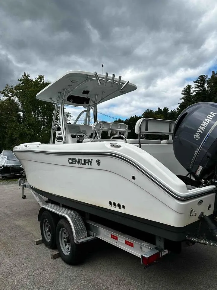 Slide: The Image of 2015 Century 2600 CC boat on trailer with Yamaha engine, under cloudy sky. - 2