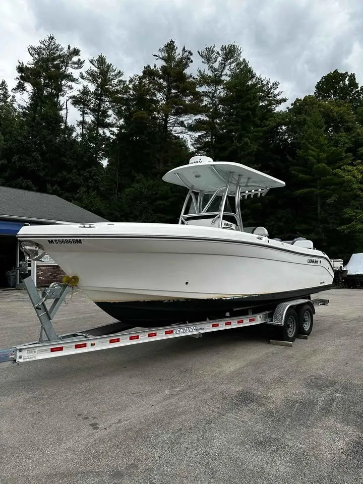 Slide: The Image of 2015 Century 2600 CC boat on trailer, parked outdoors with trees in background. - 3