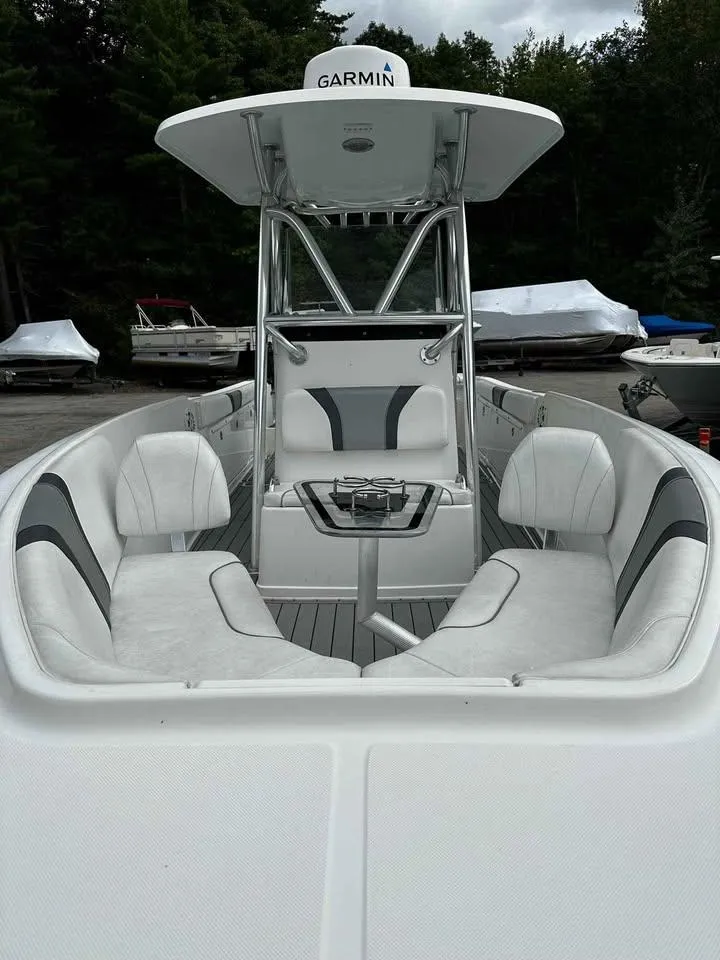 Slide: The Image of 2015 Century 2600 CC boat with white seating and Garmin equipment, docked outdoors. - 4