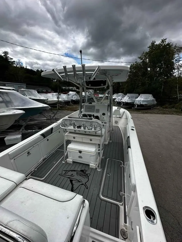 Slide: The Image of 2015 Century 2600 CC boat with T-top, docked under cloudy skies. - 5